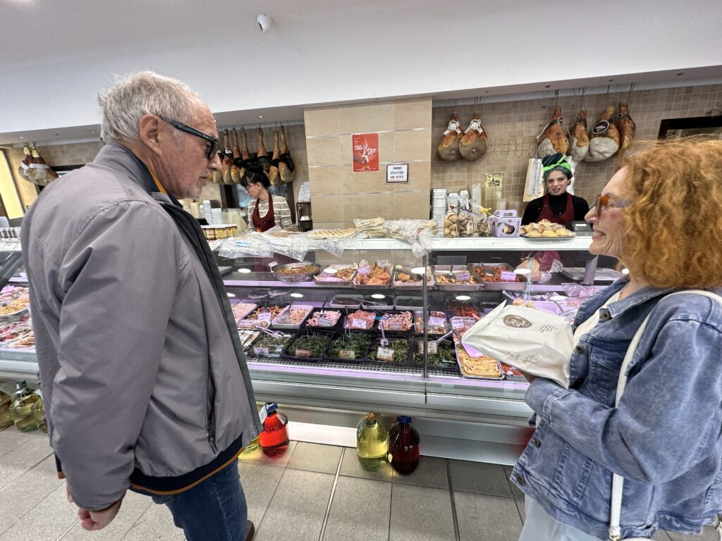 Roberto and Rosalina shopping for lunch at an Italian market — honoring daily rhythms, connection, and simple pleasures.